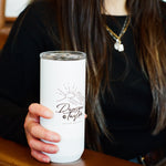 Woman holding a white tumbler with a logo in a cafe setting