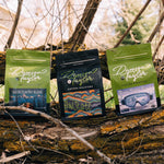 Three coffee bags from Dawson Taylor on a wooden log with a natural background