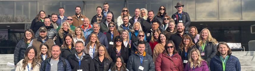 Group of people posing for a photo on steps outside a building